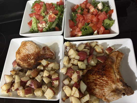Honey-glazed pork chops with garlic-butter red potatoes and a tomato salad