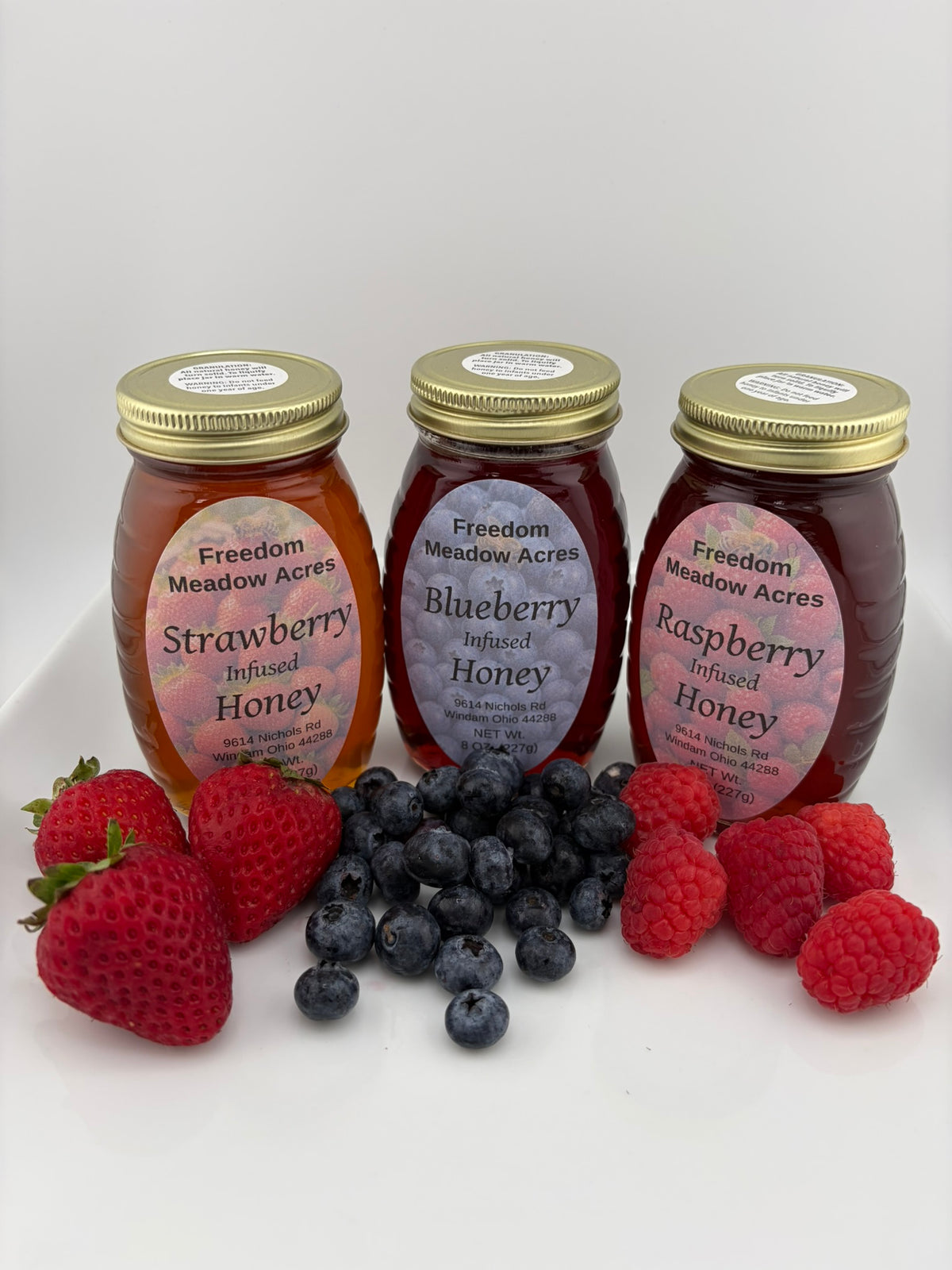 Three glass jars of our popular infused honey.