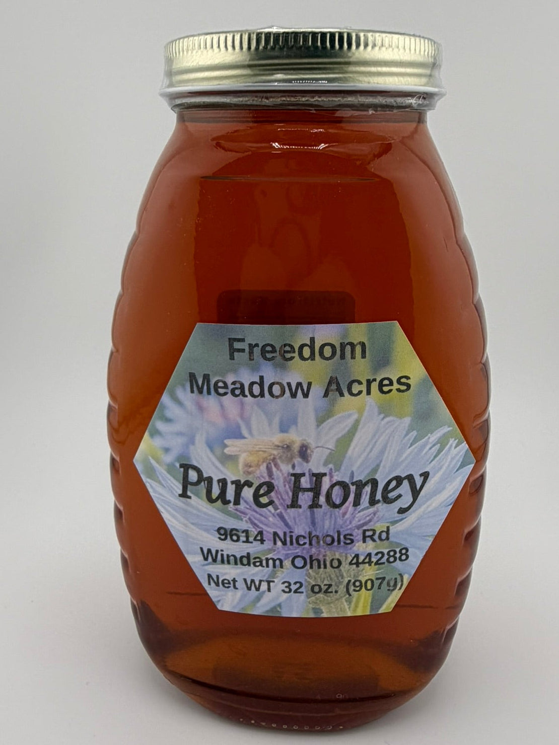 A 32 oz glass jar of pure honey.